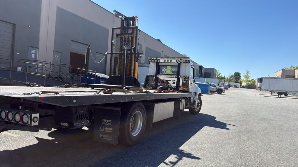 Industrial equipment removal in Abbotsford, BC - an electric lift stacker loaded for pickup